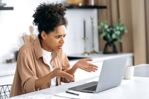 Femme contrariée devant un ordinateur portable