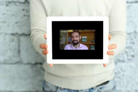 Homme montrant l'affichage d'une tablette