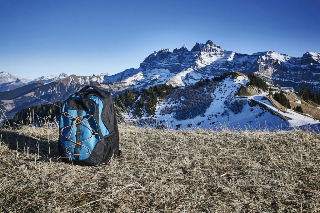 Switzerland, Portes du Soleil, Champery, backpack at hillside