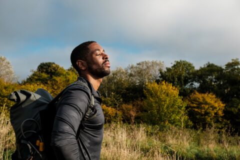 Hiker breathing fresh air in scenic forest landscape